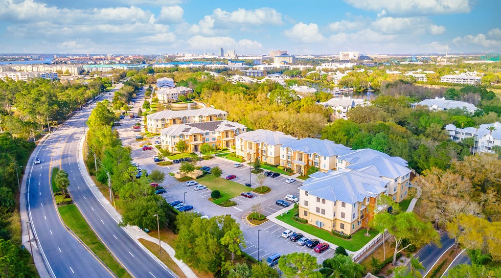 an aerial view of a neighborhood with cars parked on the side of the road