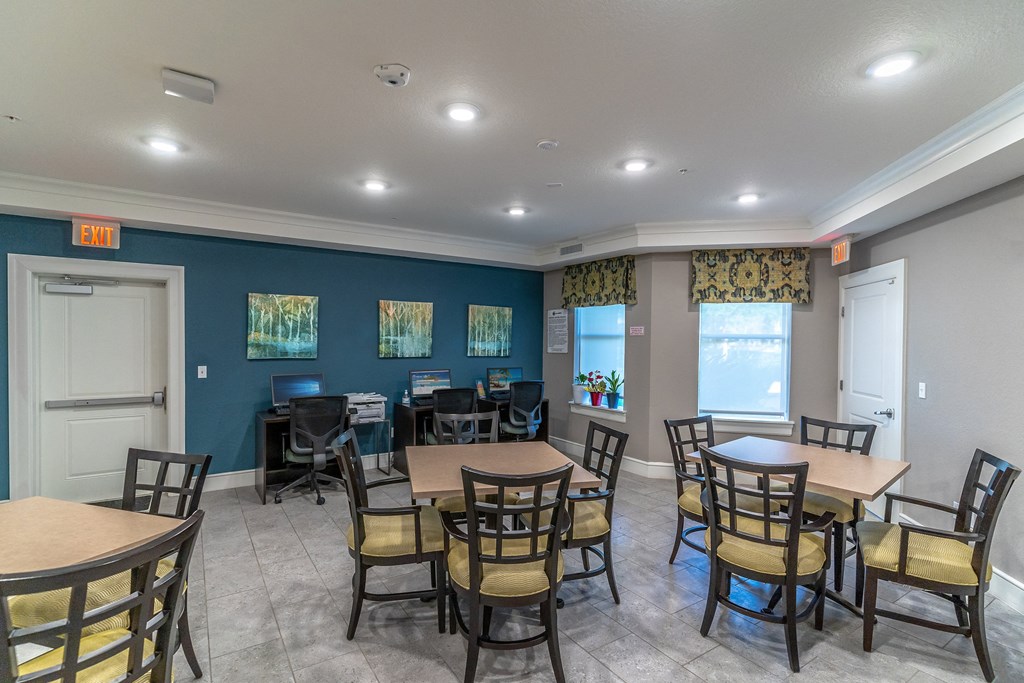 a seating area with tables and chairs