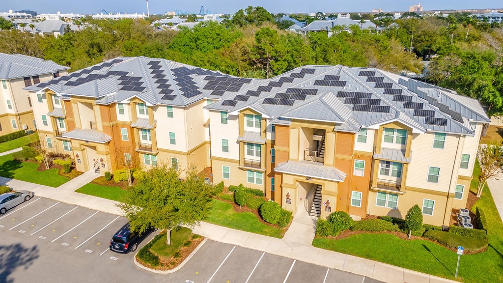 an aerial view of an apartment complex with solar panels on the roof
