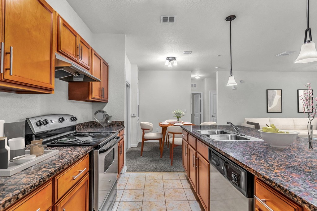 a kitchen with wooden cabinets and granite countertops