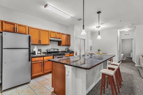 a kitchen with a granite counter top and wooden cabinets