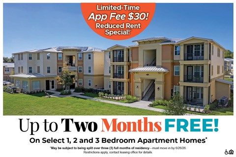 Apartment complex with a sign offering a free app and reduced rent.