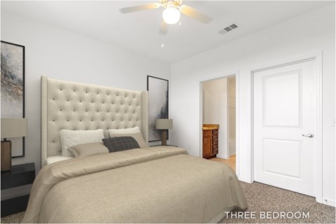 A bedroom with a large bed and a ceiling fan.