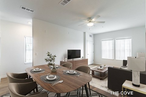 A dining room with a wooden table set for six.
