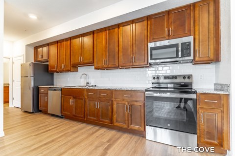 A kitchen with wooden cabinets and stainless steel appliances.