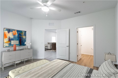 A bedroom with a bed, dresser, and painting.