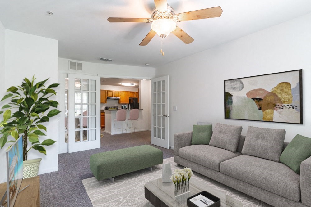 a living room with a couch and a ceiling fan
