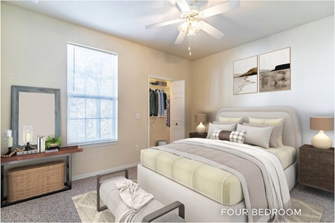 A bedroom with a large bed and a ceiling fan.