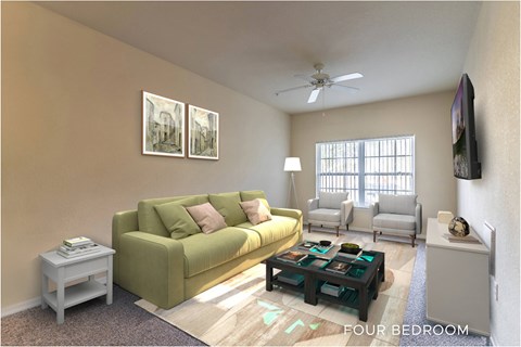 A living room with a green couch and a flat screen TV mounted on the wall.