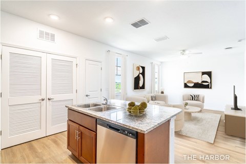 A modern kitchen with a wooden island and stainless steel appliances.