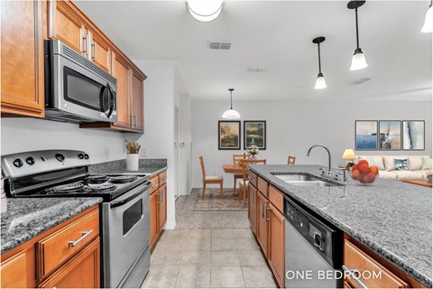 A kitchen with granite countertops and wooden cabinets.
