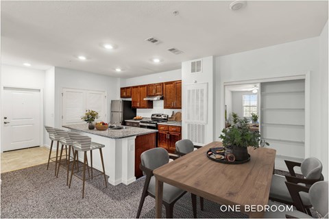 A kitchen with a table and chairs in the middle of the room.