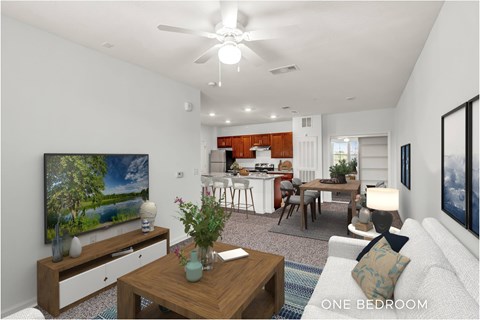 A modern living room with a television, a dining area, and a kitchen in the background.