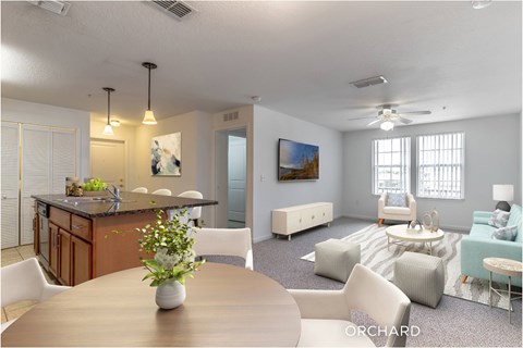 A modern living room with a dining table and chairs.