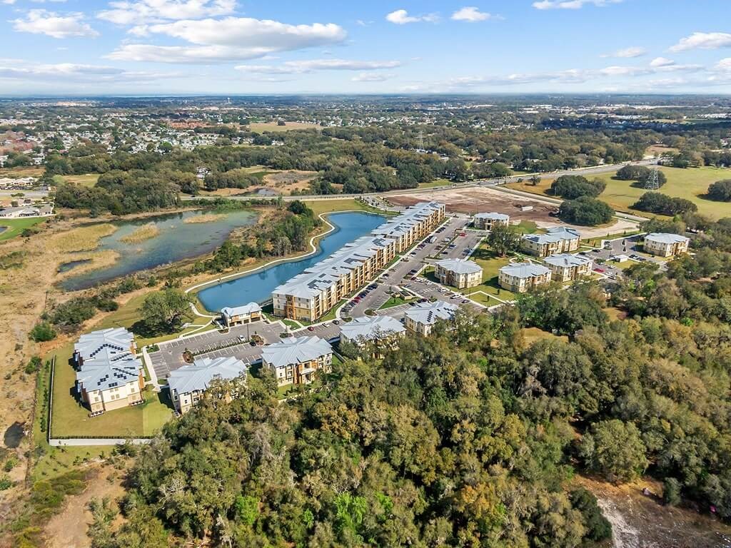 an aerial view of a city with buildings and a lake