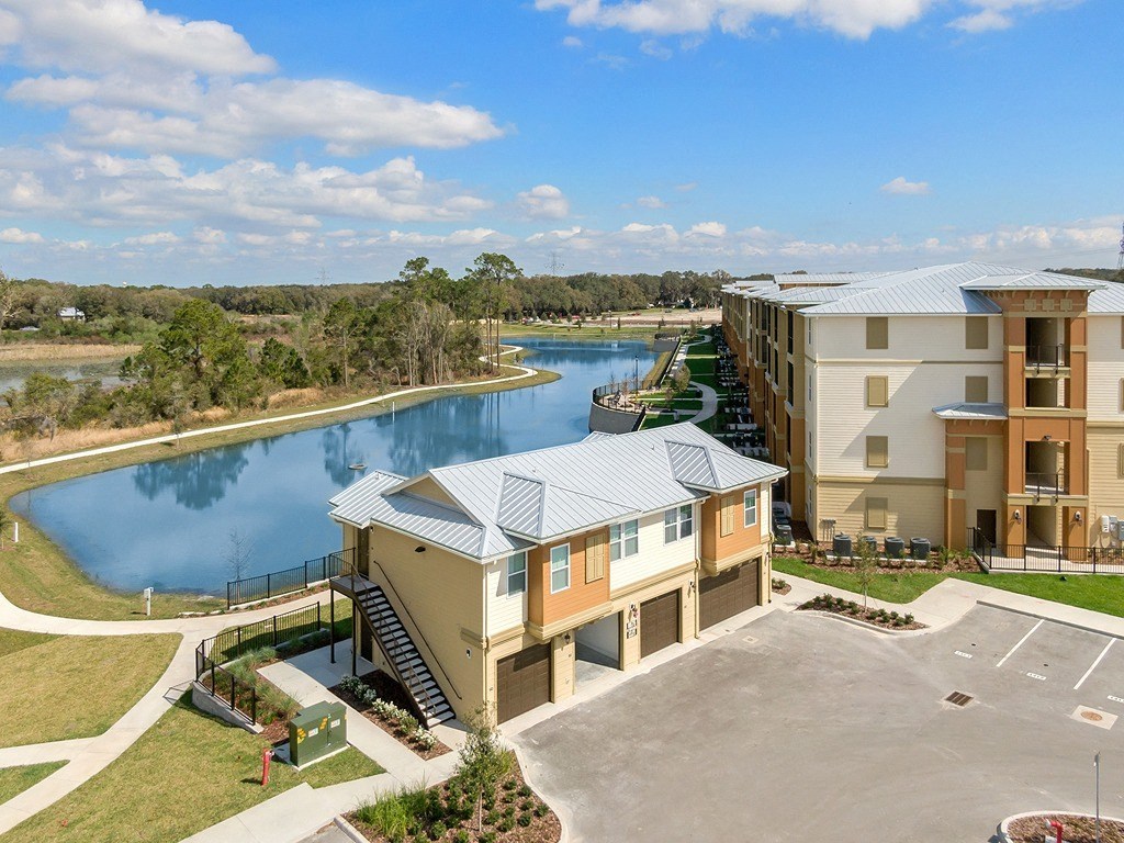 an aerial view of carriage homes with lake behind