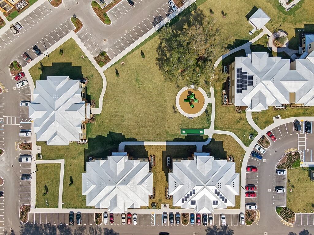 an overhead view of a parking lot and buildings with a park