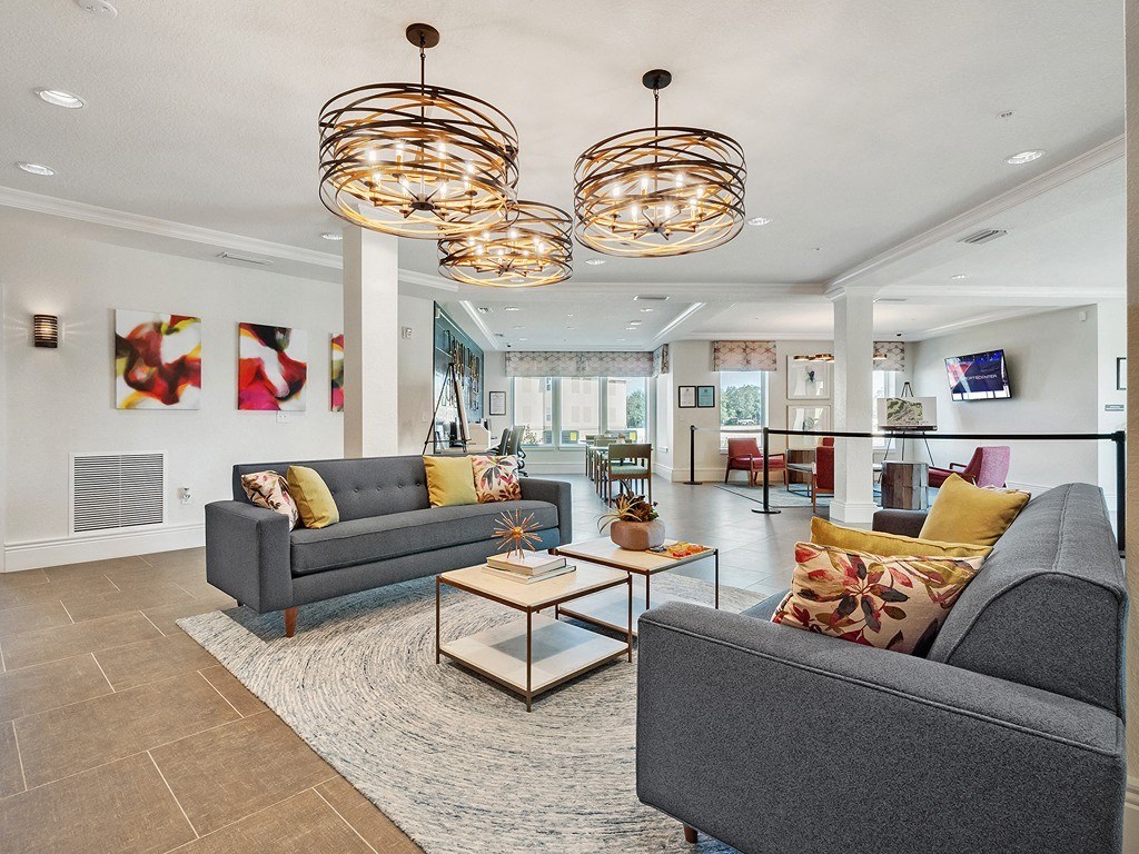 a view of the lobby of a hotel with couches and chairs