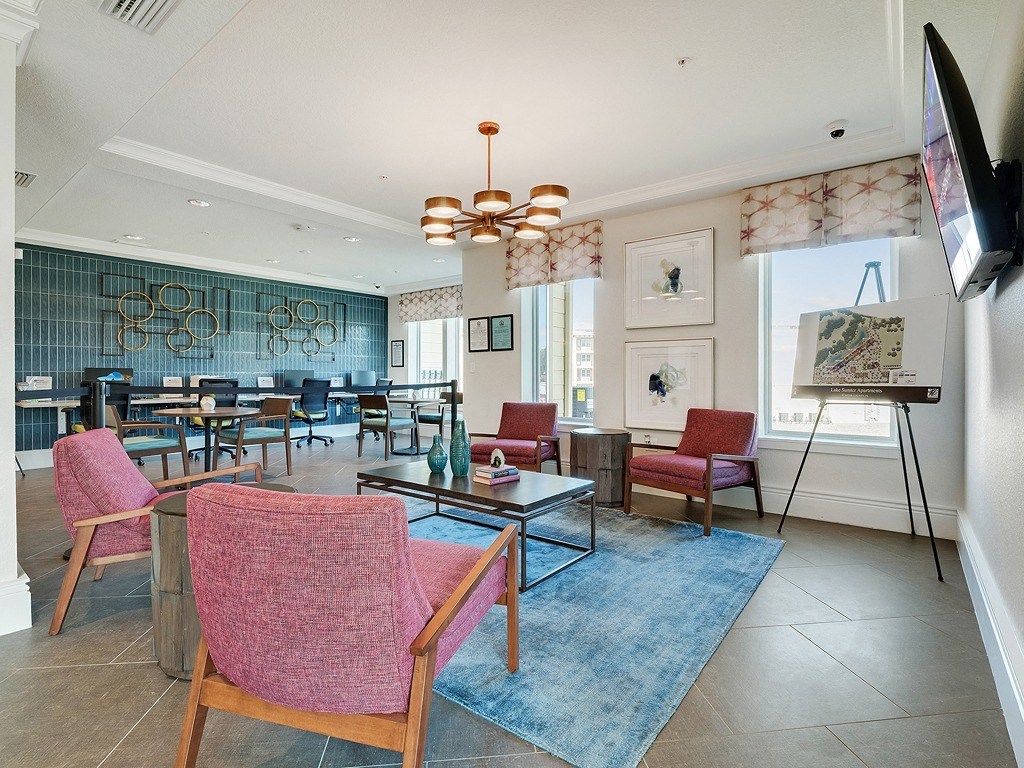 a living room with chairs and tables and a television