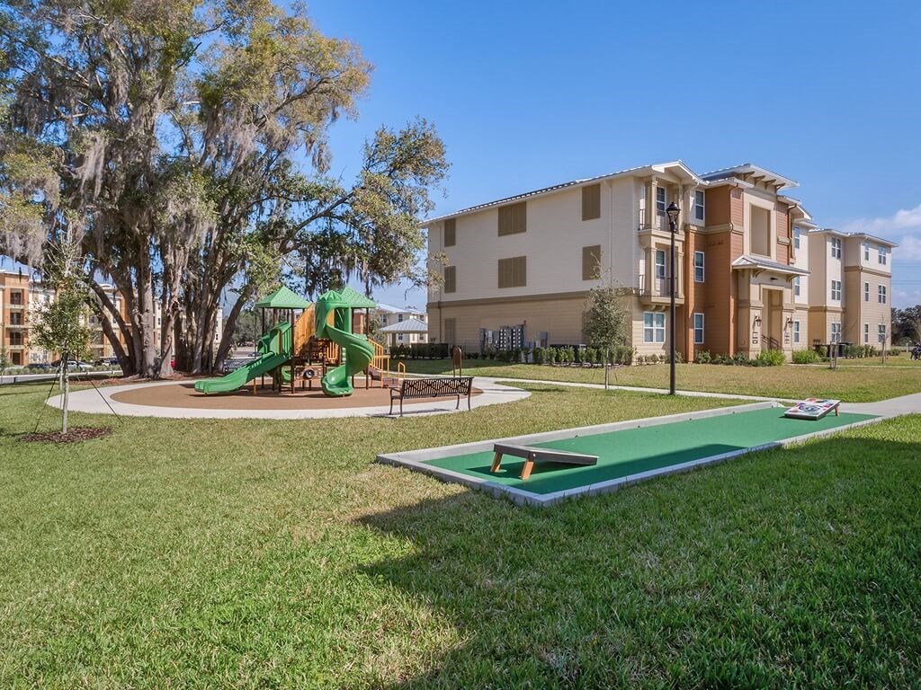 a park with a playground and a game on the grass