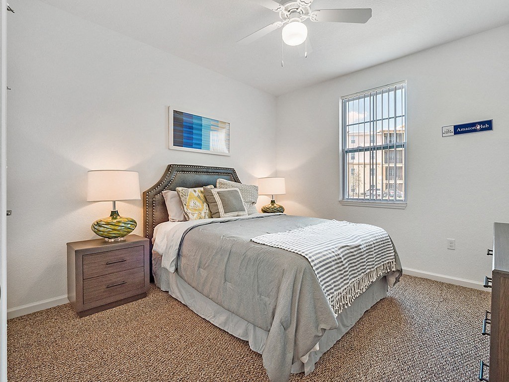 a bedroom with a bed and a ceiling fan