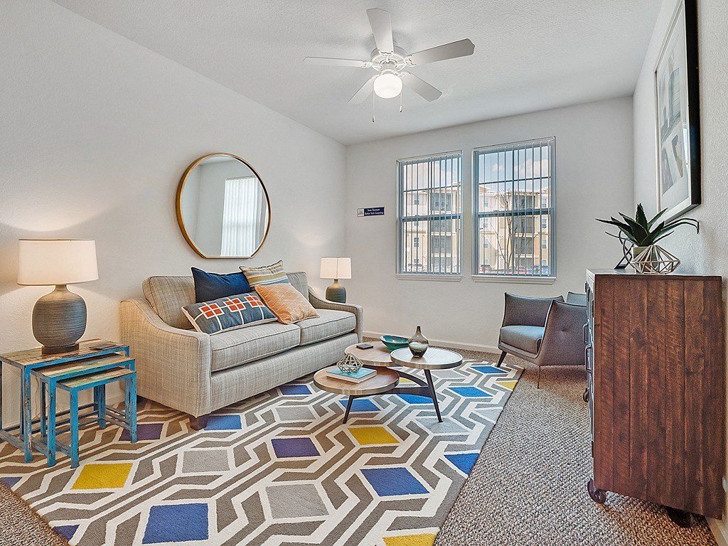 a living room with a couch and a rug