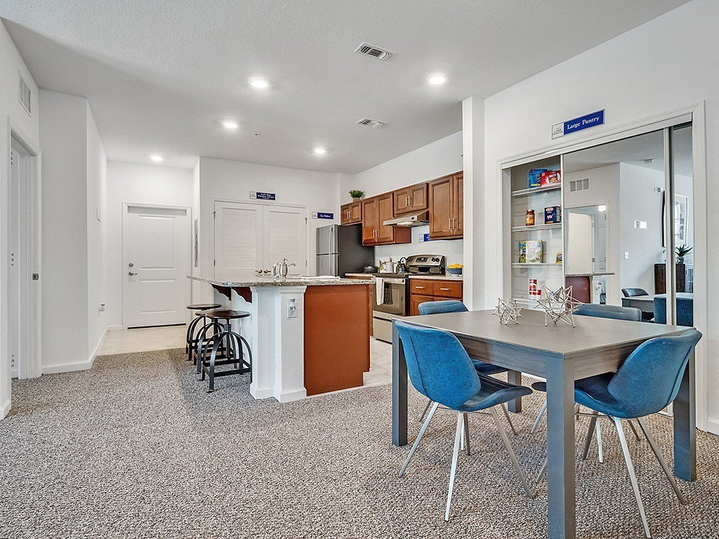 a kitchen and dining area with a table and chairs