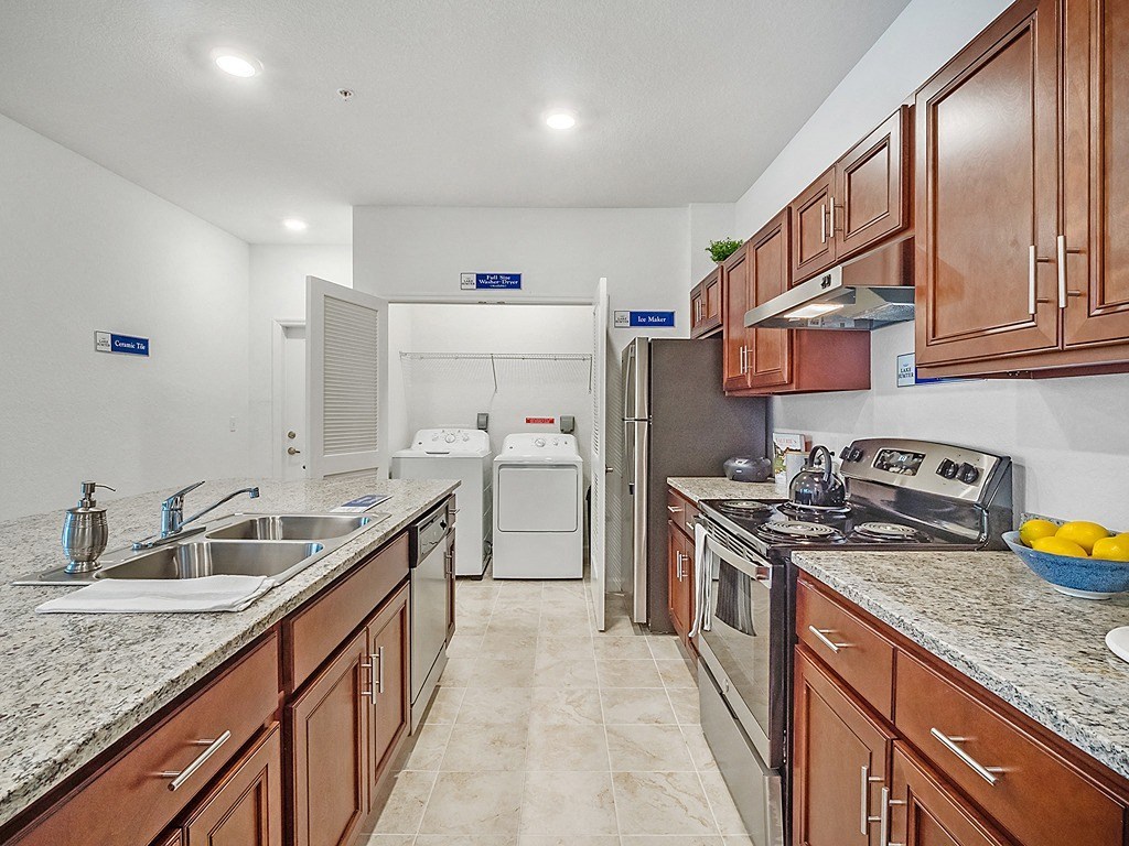 a kitchen with wooden cabinets and granite counter tops
