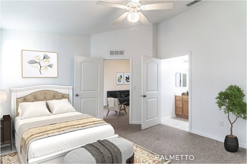 A bedroom with a large bed and a ceiling fan.