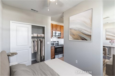 A bedroom with a large bed and a painting on the wall.
