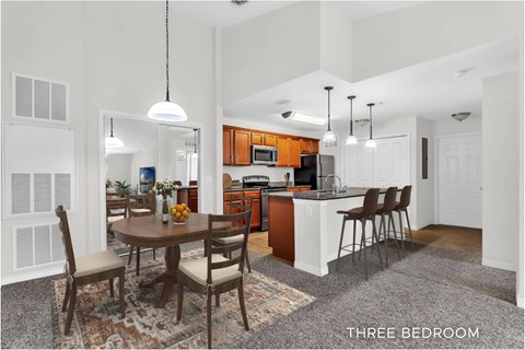A kitchen with a table and chairs in the middle of the room.