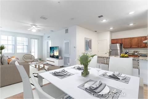 A modern dining room with a white table set for two.