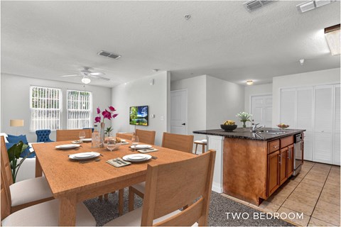 A dining room with a wooden table and chairs.