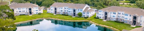 an aerial view of a large apartment complex next to a lake