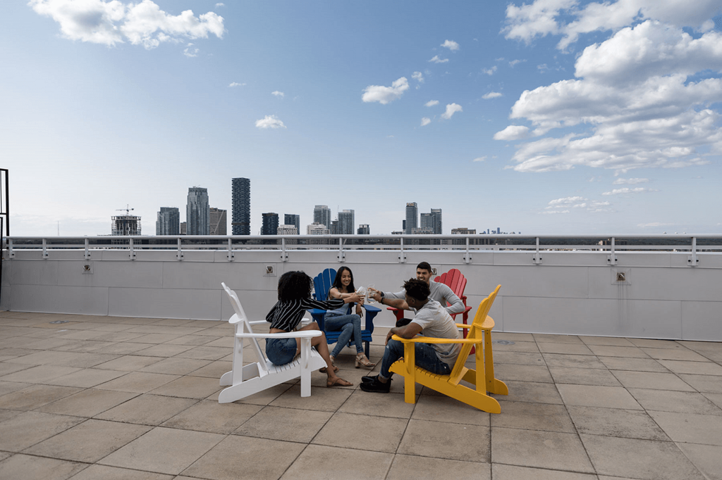 a group of people sitting around a table on a roof