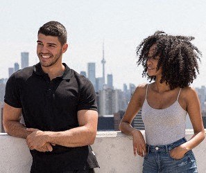 a man and a woman standing on a balcony