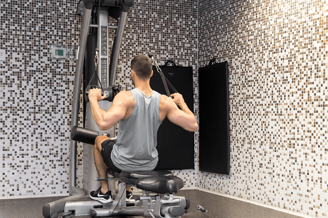 a man working out in a gym on a machine