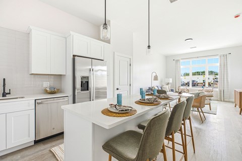 A modern kitchen with a dining table set for four.