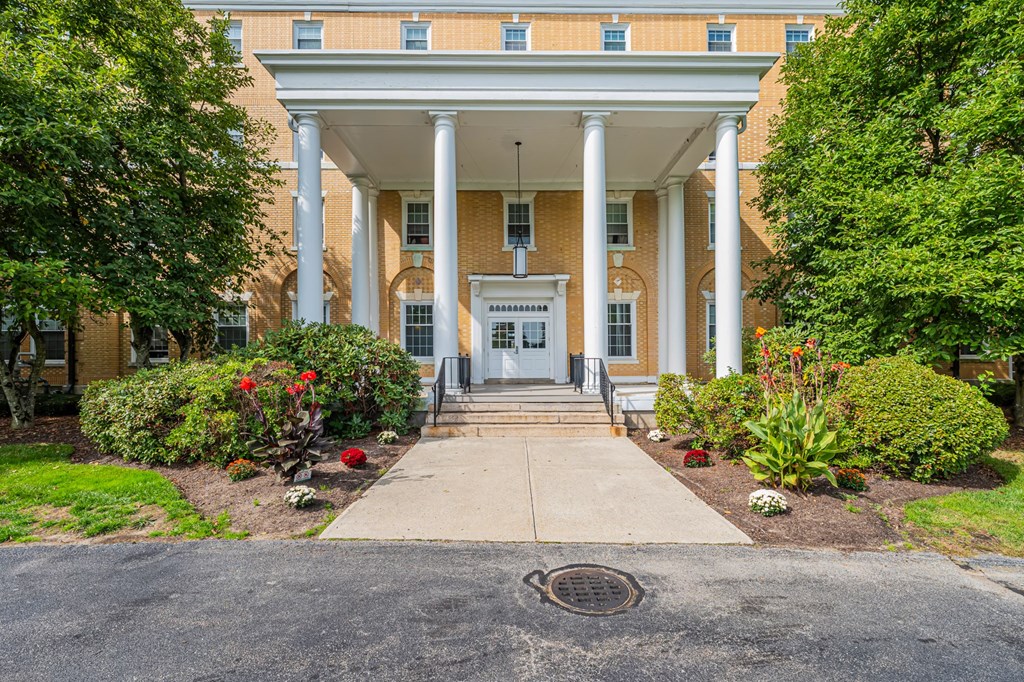 A building with a white entrance and pillars.