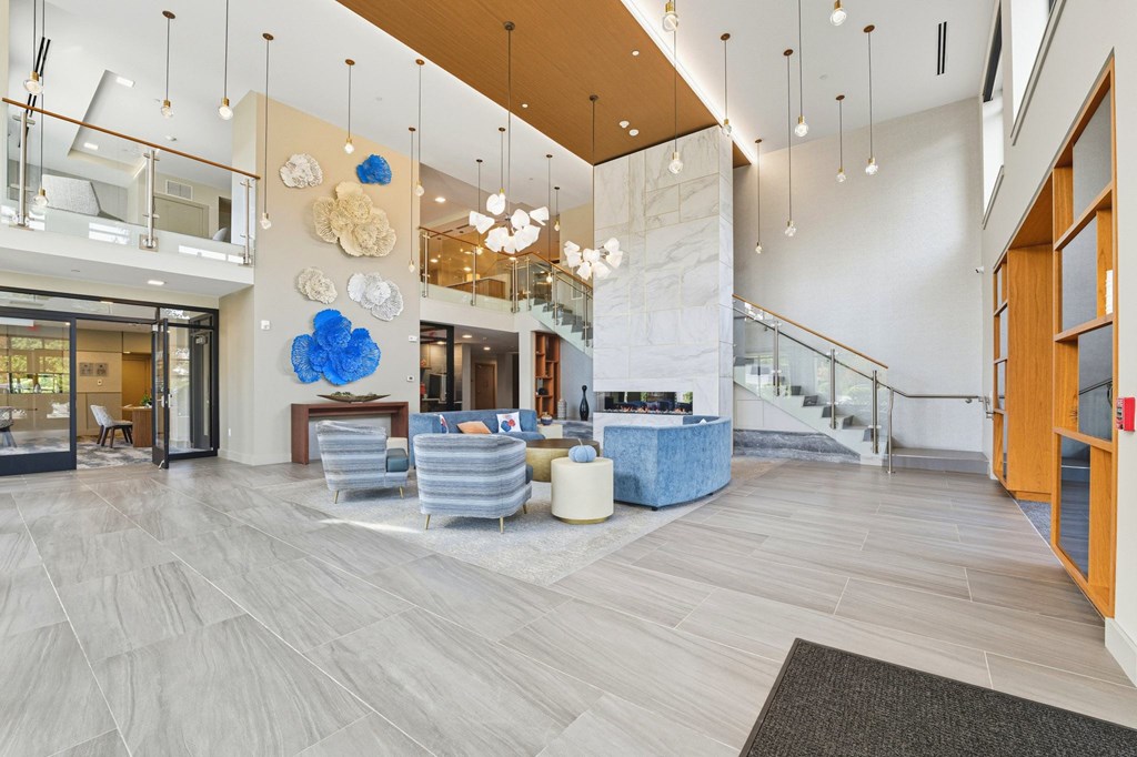 A spacious lobby with a staircase and a blue and white decorative piece.