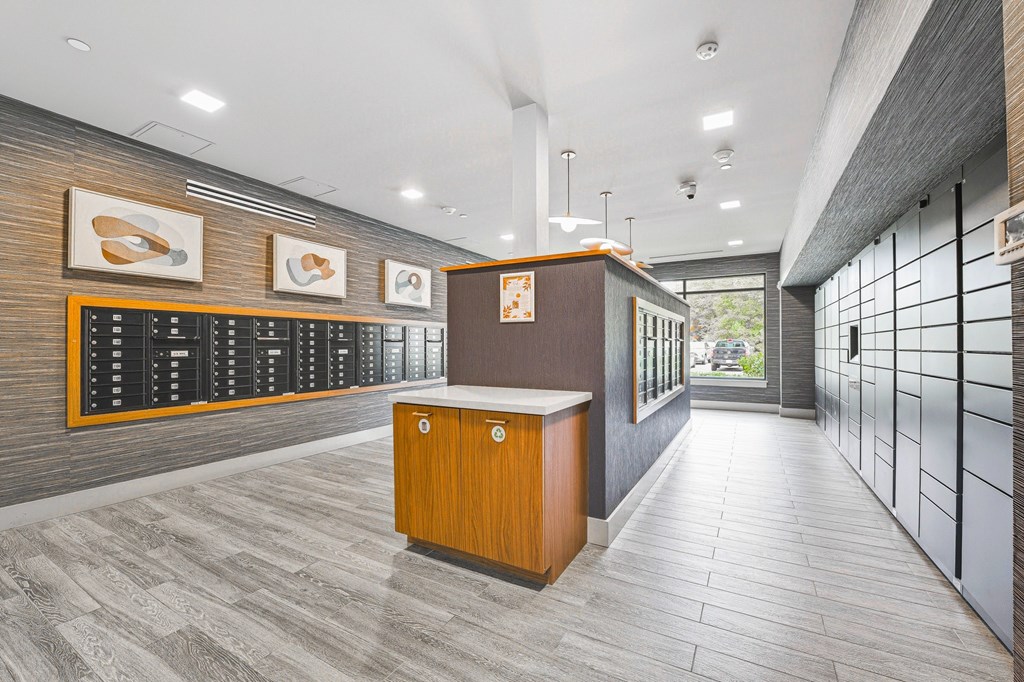 A reception area with a wooden counter and a black board on the wall.