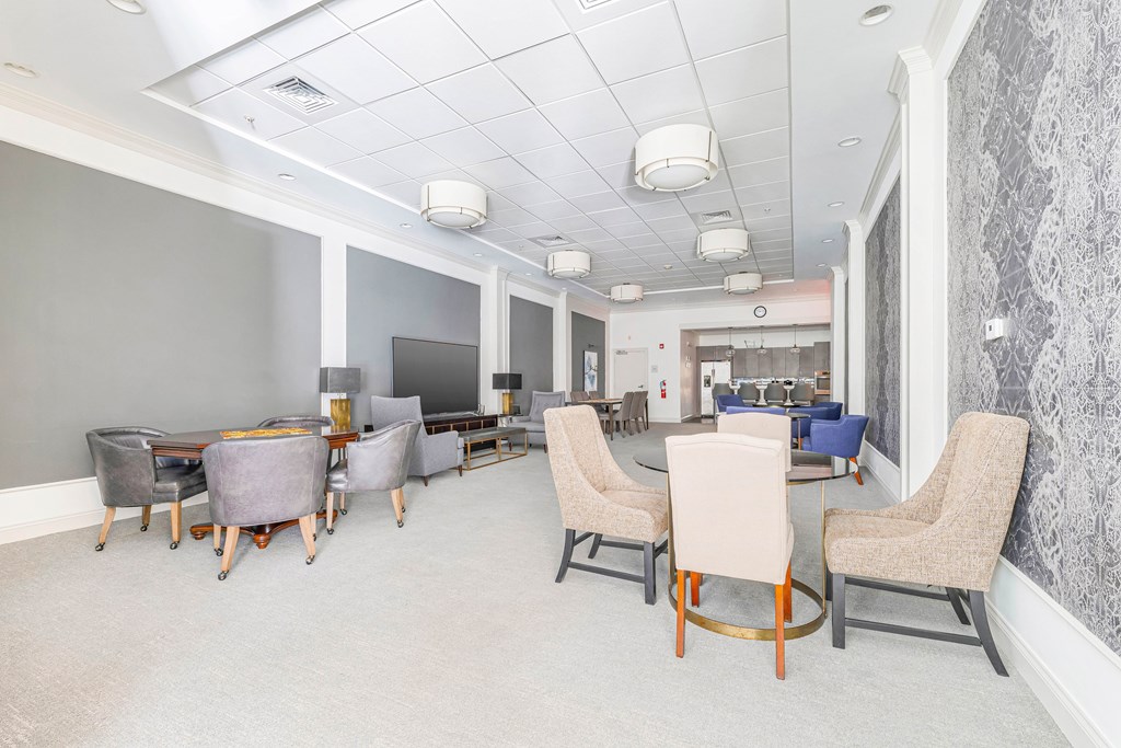 A conference room with a long table and chairs.