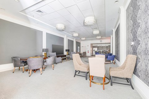 A conference room with a long table and chairs.