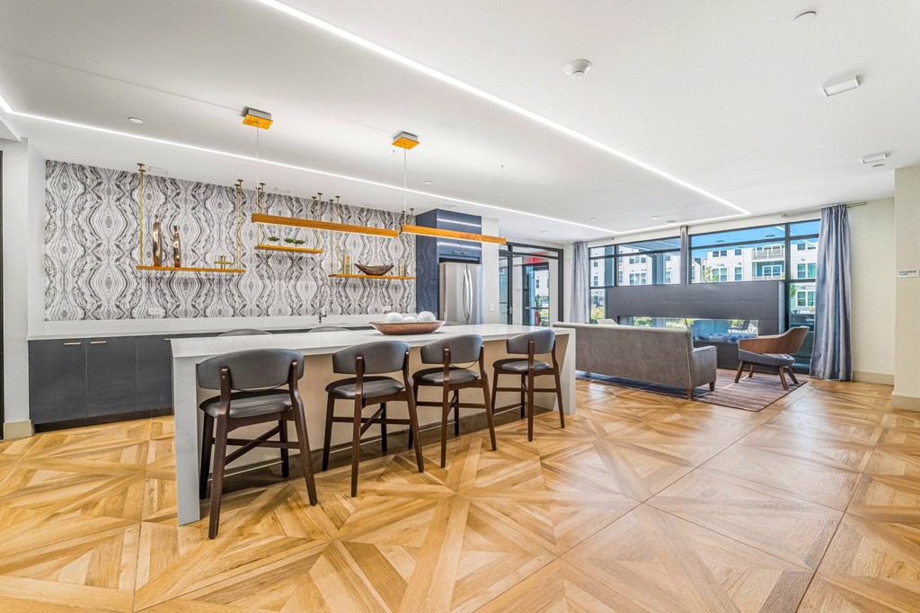 A kitchen with a dining table and chairs.