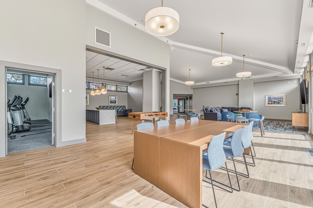 A conference room with a long table and chairs.