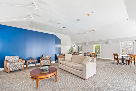 A living room with a couch, chairs, and a coffee table.