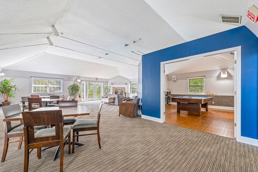 A room with a blue accent wall and a carpeted floor.