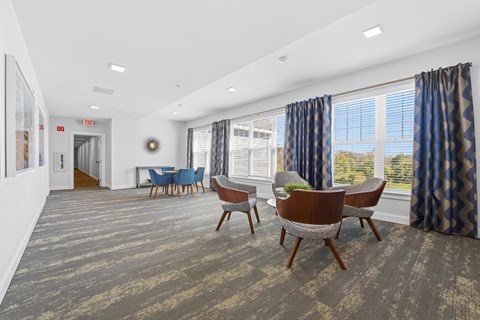 A conference room with a long table and chairs.