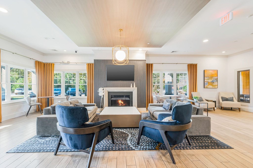 A living room with a fireplace and a TV.