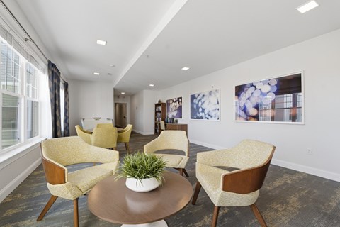 A living room with a table and chairs.